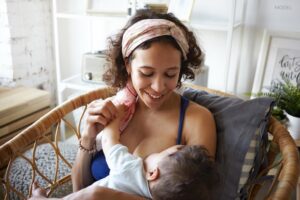 Woman breastfeeding her son at home.