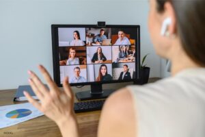 Woman on a videoconferencing call, looking at participants.