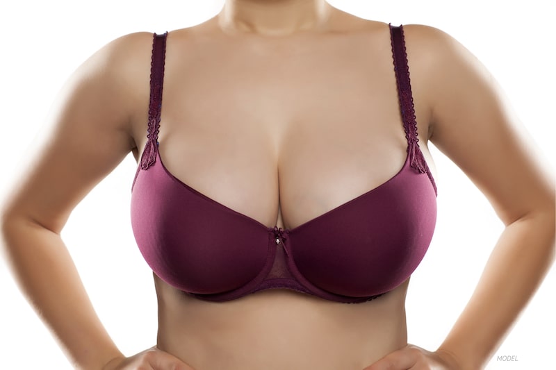 Woman with voluptuous breasts in maroon bra
