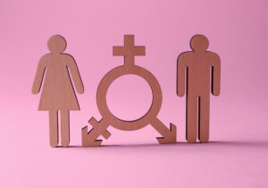 Neutral female and male symbols are combined and set between female and male figures against a pink background