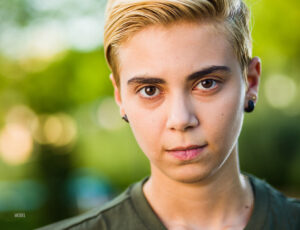 Photo of young, blonde trans or nonbinary man.