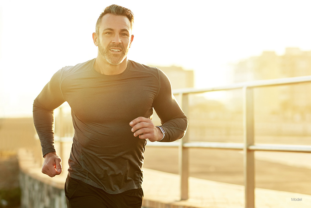 Fit man running on a bridge