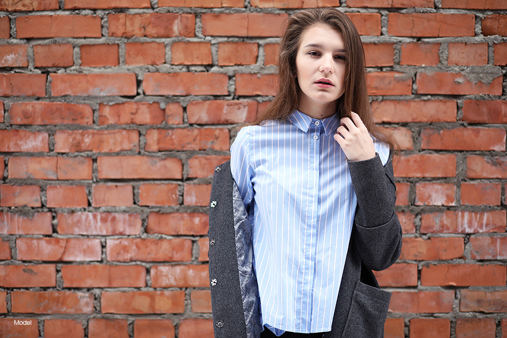 A person in a blue button up shirt