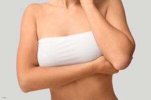 Young woman in bandeau top with beautiful breasts